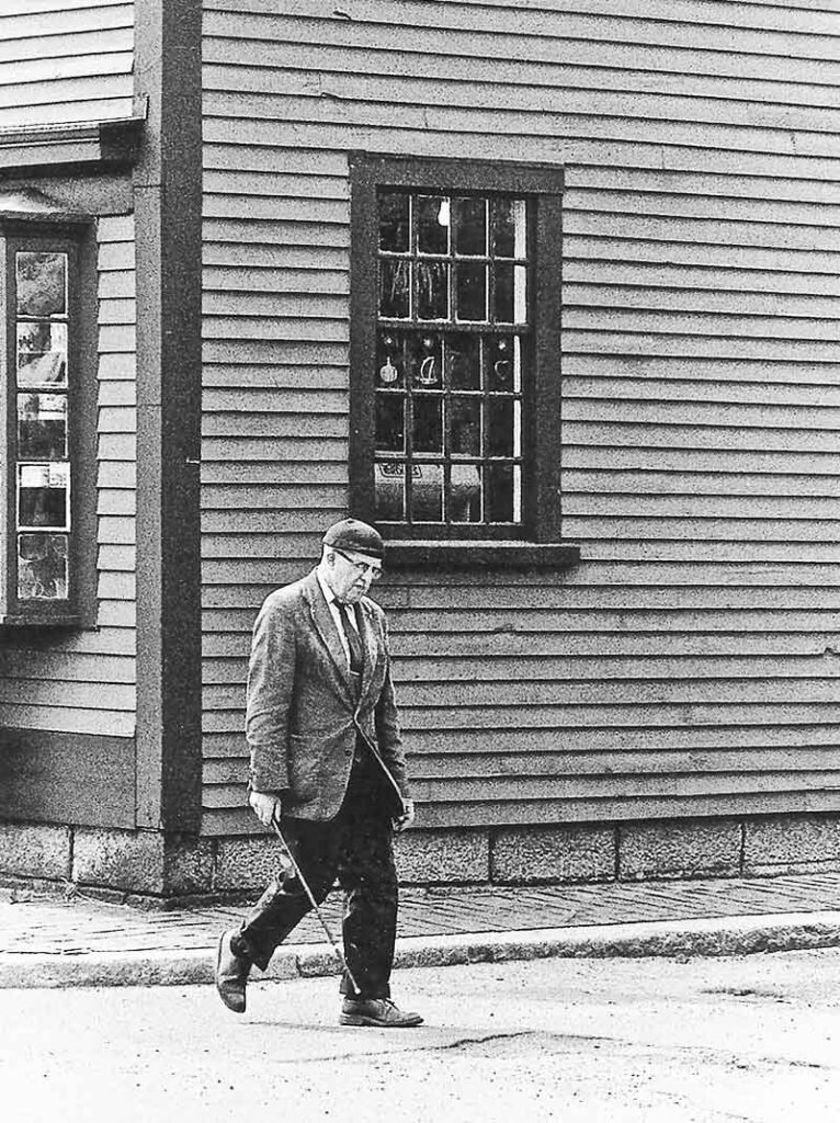 Black & white photo of QOJ walking the streets of Salem, MA